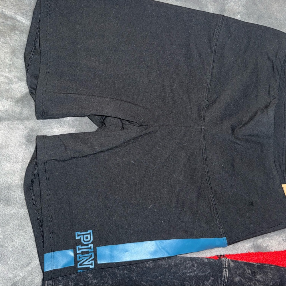 NWT Pink bike shorts never worn size medium black with blue logo name down leg